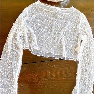 Sheer crop top embellished with pearls.